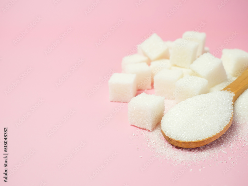 granulated sugar and sugar cubes on a pink background with space for text granulated sugar and sugar cubes on a pink background with space for text