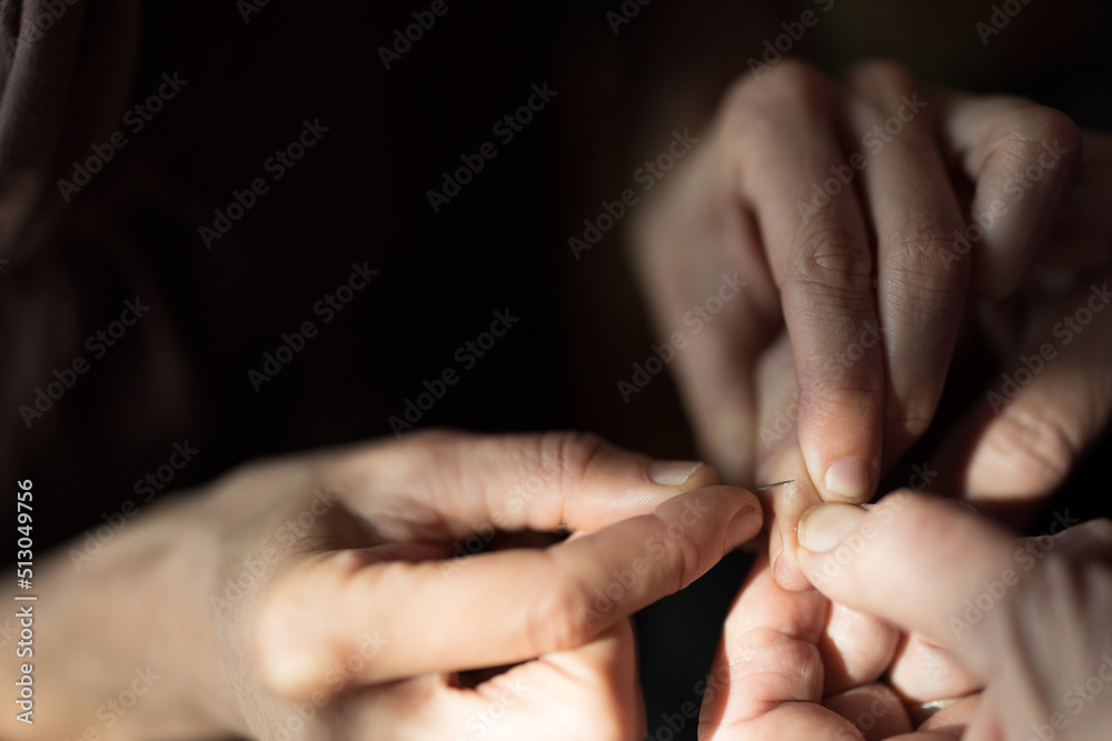 Woman Help Removing of some Thorns from Senior Woman Hands at Window better Light in Domestic Environment Close Up Woman Help Removing of some Thorns from Senior Woman Hands at Window better Light in Domestic Environment Close Up