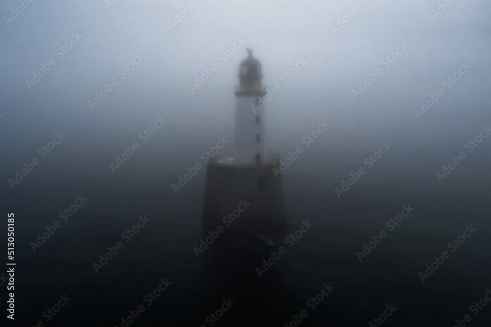 view of the historic Rattray Head Lighthouse in northern Scotland in thick and dense fog view of the historic Rattray Head Lighthouse in northern Scotland in thick and dense fog