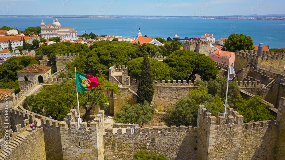 aerial top view on the Tejo River and the Temple of St. Vicente de Fora with Portuguese flag in front from the observation deck from the fortress of Saint George (Castelo de Sao Jorge)