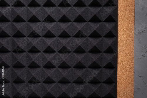 Acoustic soundproof foam and cork board at cement wall background texture. Sound isolation material
