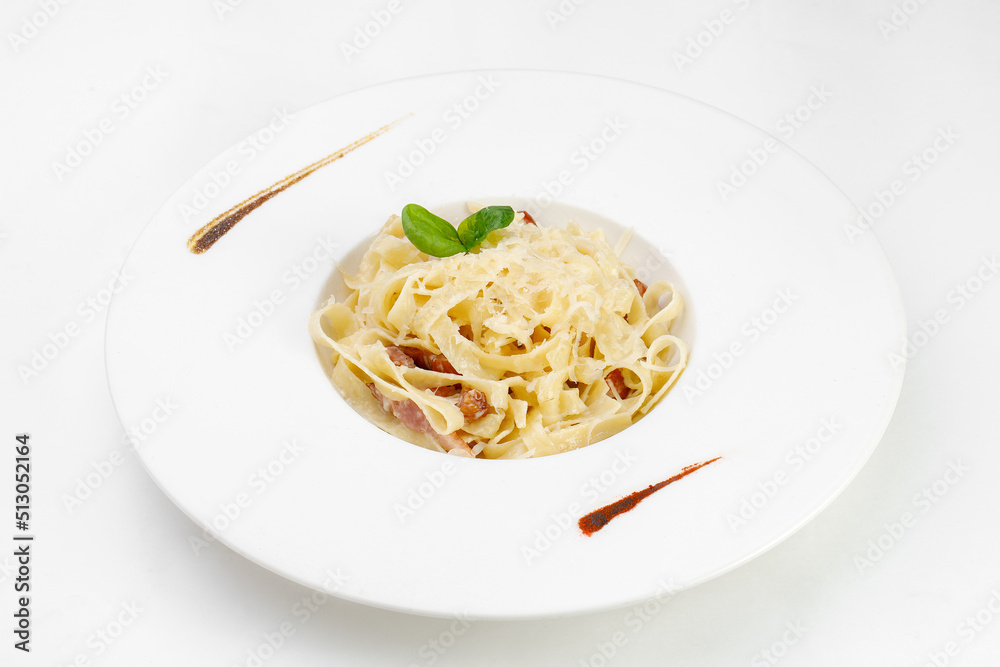 Pasta Carbonara in a plate, beautifully arranged on a white background