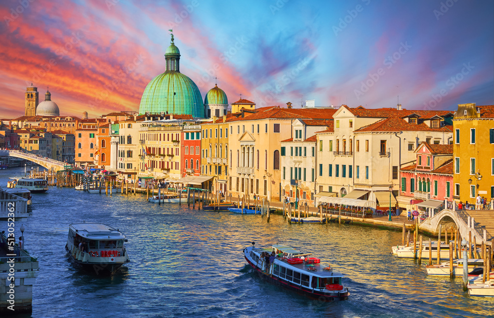 Grand Canal in Venice Italy. Panoramic view to picturesque landscape city and cathedral San Simeone Piccolo. Boat cutter on water. Sunny summery day with blue sky white clouds.
