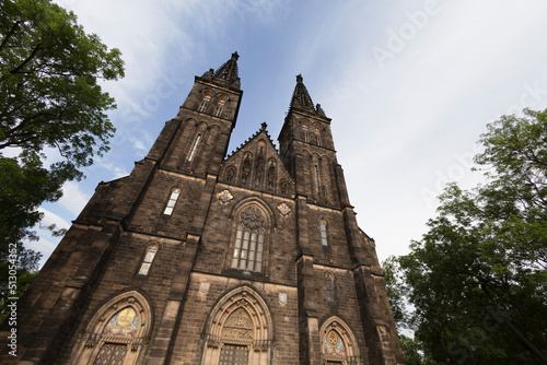 Basilica of Saint Peter and Paul (Bazilika svatého Petra a Pavla), Vysehrad, Prague, Czech Republic, Czechia - old gothic historical landmark and monument. Bottom view and wide angle distortion.
