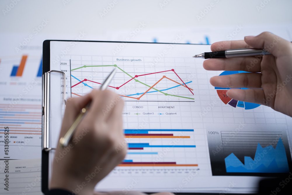 Close up of hands are working on paperworks that shows graft and chart of accounting and financial. Close up of hands are working on paperworks that shows graft and chart of accounting and financial.