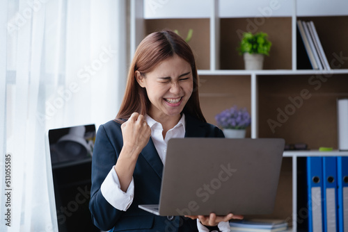 Business woman happy and cheerful for successful on project via laptop in office space.