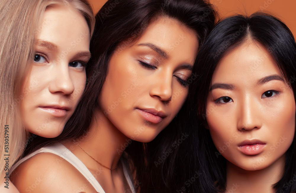 young pretty african and caucasian women posing cheerful together on brown background, lifestyle diverse nationality people concept young pretty african and caucasian women posing cheerful together on brown background, lifestyle diverse nationality people concept