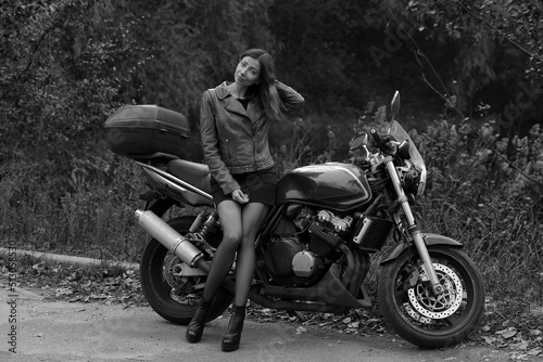 Beautiful lady with a motorcycle in black and white