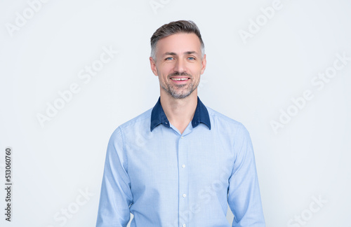 smiling mature entrepreneur in businesslike wear on grey background © be free