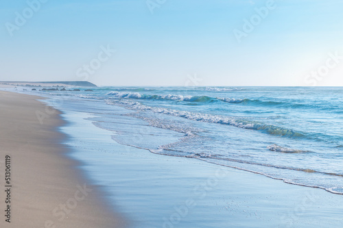 Beautiful beach Praia Da Barra and Costa Nova, famous getaways by Aveiro, Portugal. Atlantic Ocean with beautiful blue waters and clear sky