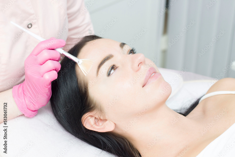 Beautiful caucasian woman leaning on a spa bed with eyes opened while doing a hyaluronic mask in a wellness center. Beautiful caucasian woman leaning on a spa bed with eyes opened while doing a hyaluronic mask in a wellness center.