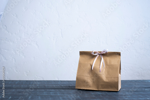 Gift. Paper bag. Cardboard box. Gift bag on the table.