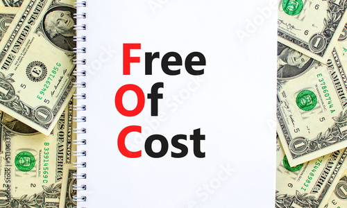 FOC free of cost symbol. Concept words FOC free of cost on white note on a beautiful background from dollar bills. Business and FOC free of cost concept. Copy space.