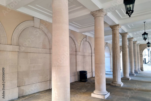 Beautiful light concrete columns against the background of the building.