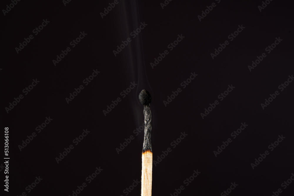 Burnt match with smoke on a dark background. Burnt match with smoke on a dark background.