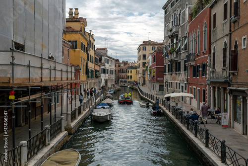 Narrow canal in the city of Venice on a summer morning