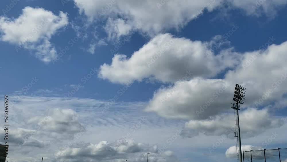 Running white clouds against the blue sky above the lighting mast. Accelerated video. Timelapse. No sound. Running white clouds against the blue sky above the lighting mast. Accelerated video. Timelapse. No sound.