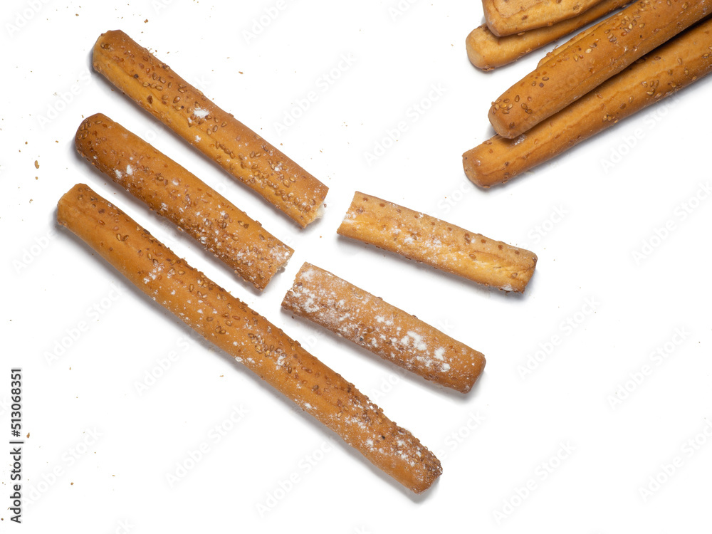 Sesame biscuits on a white background. Biscuits are elongated in the form of sticks. Bread products. Flour products. Healthy food. Sesame biscuits on a white background. Biscuits are elongated in the form of sticks. Bread products. Flour products. Healthy food.