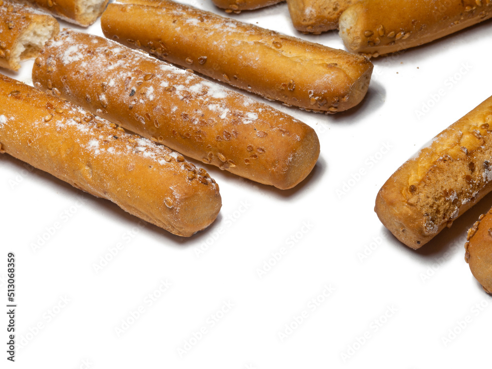 Sesame biscuits on a white background. Biscuits are elongated in the form of sticks. Bread products. Flour products. Healthy food. Sesame biscuits on a white background. Biscuits are elongated in the form of sticks. Bread products. Flour products. Healthy food.