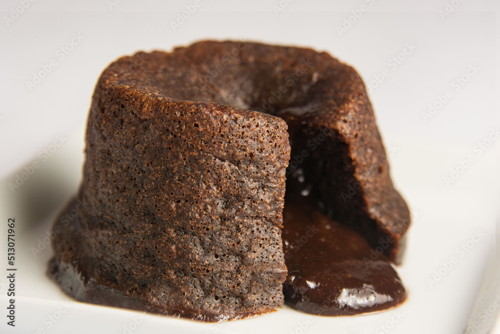 chocolate petit gateau, open with the filling dripping. White background chocolate petit gateau, open with the filling dripping. White background