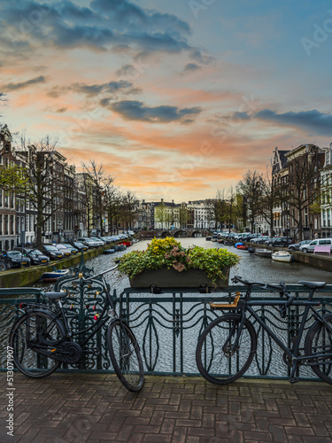 Photography Cycles and canal with dutch buildings in Amsterdam, Netherlands