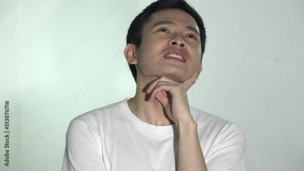 An Asian Male Thinking Isolated An Asian Male Thinking Isolated