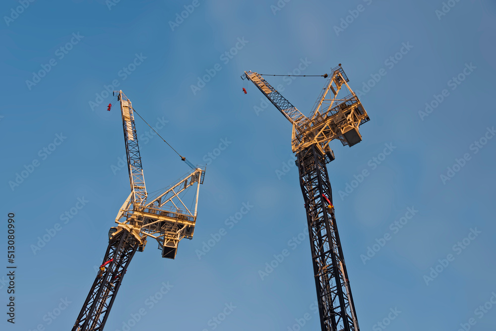 Big couple of cranes on the construction site. Big couple of cranes on the construction site.