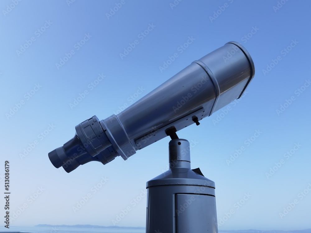 binocular isolated on the blue sky watching on the sea binocular isolated on the blue sky watching on the sea