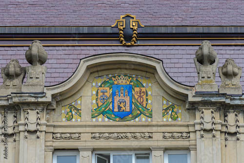 Lviv, Ukraine - June, 2022: PROSP. SHEVCHENKA, 17-19 – The prosecutor's office in Lviv region. Ornamental frieze made of glass mosaic (Henryk Uziemblo, 1908) in the center the coat of arms of Lviv.