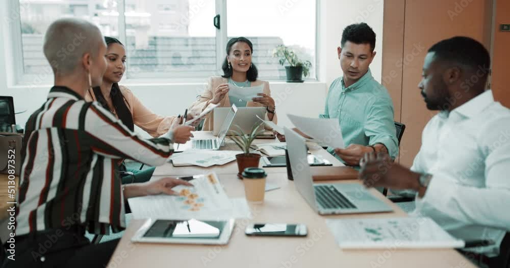 Diverse group of businesspeople passing paperwork during meeting in office boardroom. Ambitious colleagues analysing reports and documents while planning and brainstorming strategies in startup agency
