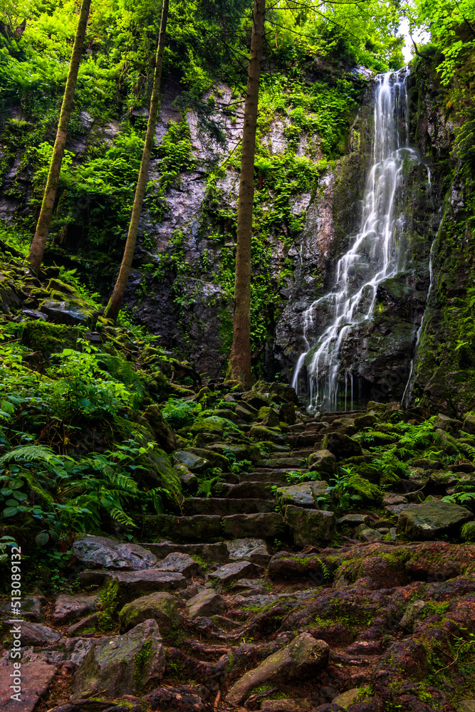Burgbach Waterfall in Black Forest Germany. Recorded in summer He falls down a cliff between trees