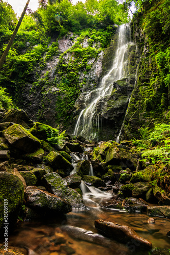 Burgbach Waterfall in Black Forest Germany. Recorded in summer He falls down a cliff between trees