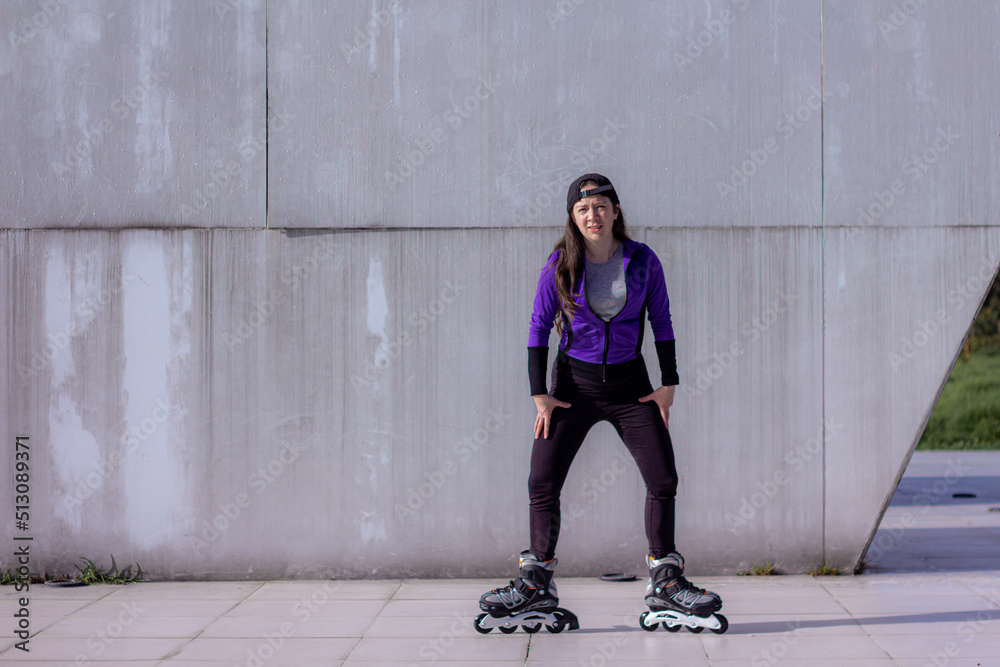 young sporty woman practicing inline skating in an urban setting young sporty woman practicing inline skating in an urban setting