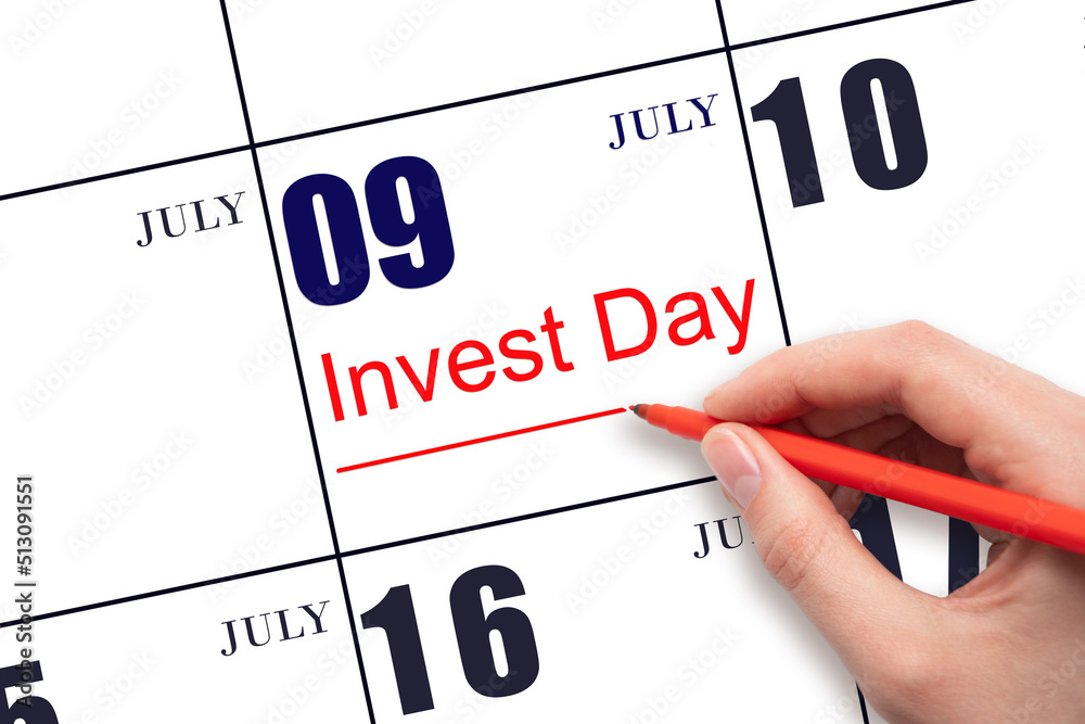 Hand drawing red line and writing the text Invest Day on calendar date July 9. Business and financial concept.