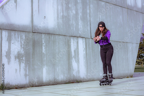 young sporty woman practicing inline skating in an urban setting