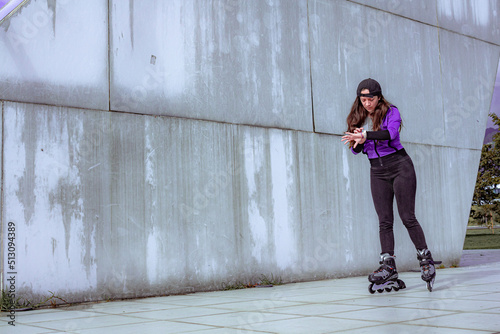 young sporty woman practicing inline skating in an urban setting