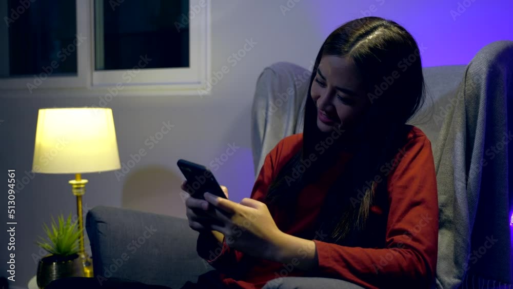 Asian woman chat on mobile at home. Relax and lifestyle at night time.