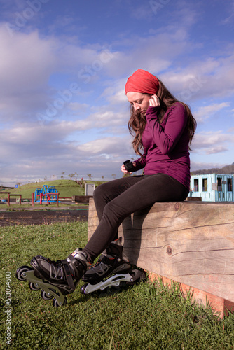 young sporty woman practicing inline skating in an urban setting. Preparing herself to skate.