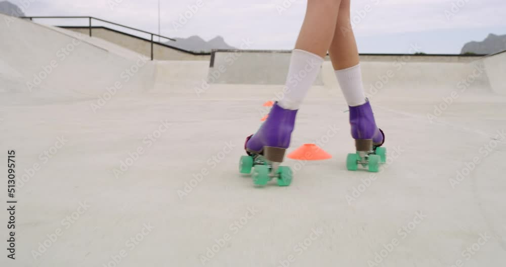 Closeup of female legs roller skating outside in a skate park. Skilled skater girl or person riding fast through cones. Swerving with vintage colorful roller skates practicing for sports competition