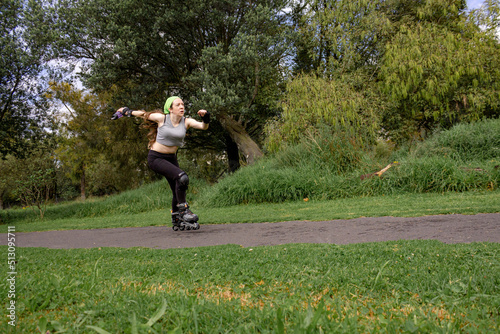 young sporty woman practicing inline skating in an urban setting. High quality photo