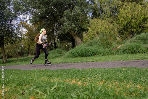 young sporty woman practicing inline skating in an urban setting. High quality photo