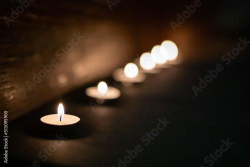 candle on flame at night on a black background