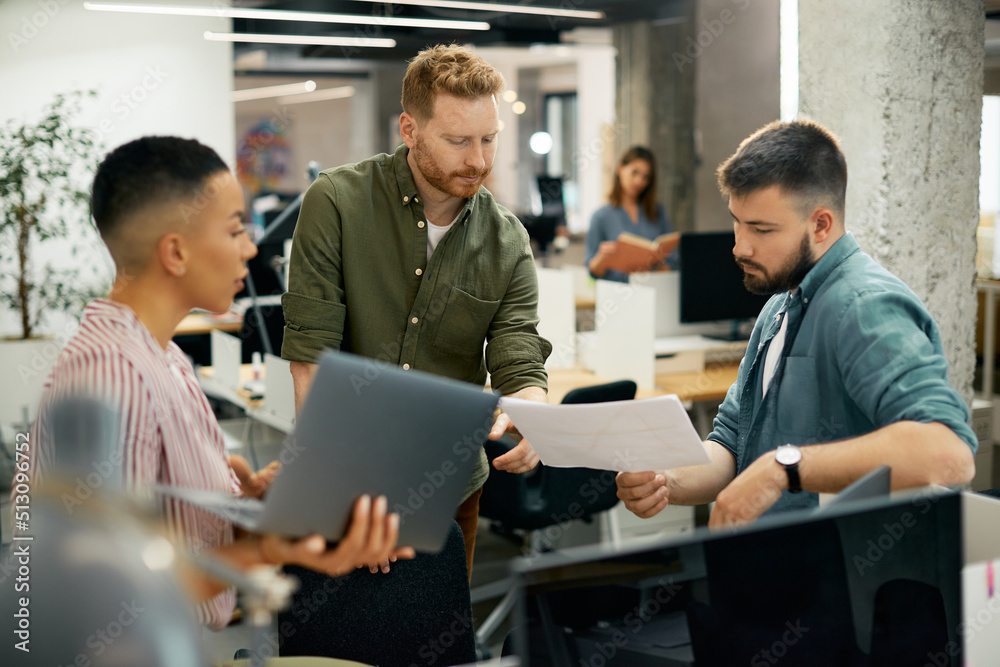 Group of entrepreneurs cooperating during business meeting in office. Group of entrepreneurs cooperating during business meeting in office.