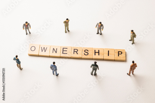 businessman figures at ownership words photo