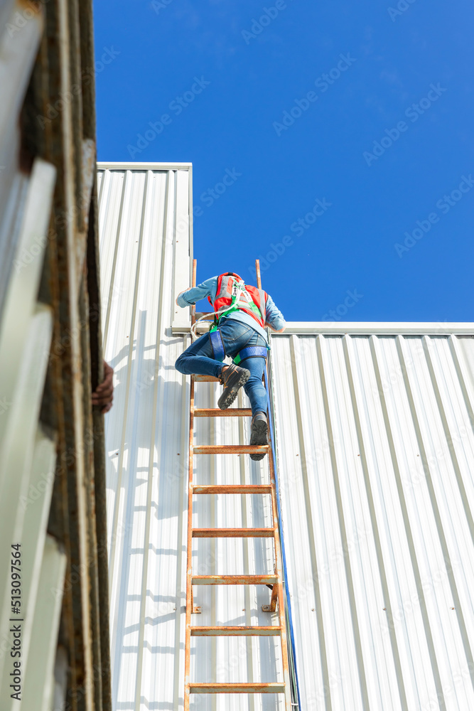 Engineering or worker descended the fire escape to the safe zone. Man in Fire escape to the roof. Worker climbing down fire escape ladder
