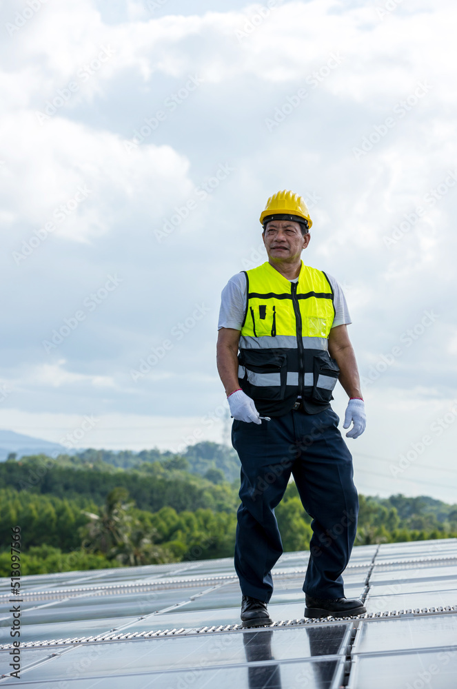 Engineer working setup Solar panel at the roof top. Engineer or worker work on solar panels or solar cells on the roof of business building Engineer working setup Solar panel at the roof top. Engineer or worker work on solar panels or solar cells on the roof of business building