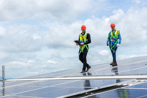 Engineer working setup Solar panel at the roof top. Engineer or worker work on solar panels or solar cells on the roof of business building