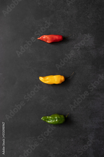 Three colorful chili peppers in a column