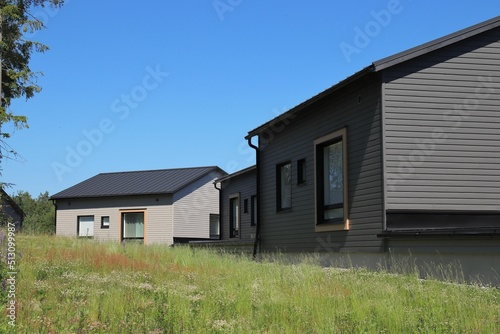 Modern gray wooden detached houses in a suburb. Living close to the nature and services.  photo