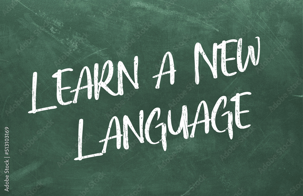 Learn a New Language written on the green chalkboard Learn a New Language written on the green chalkboard